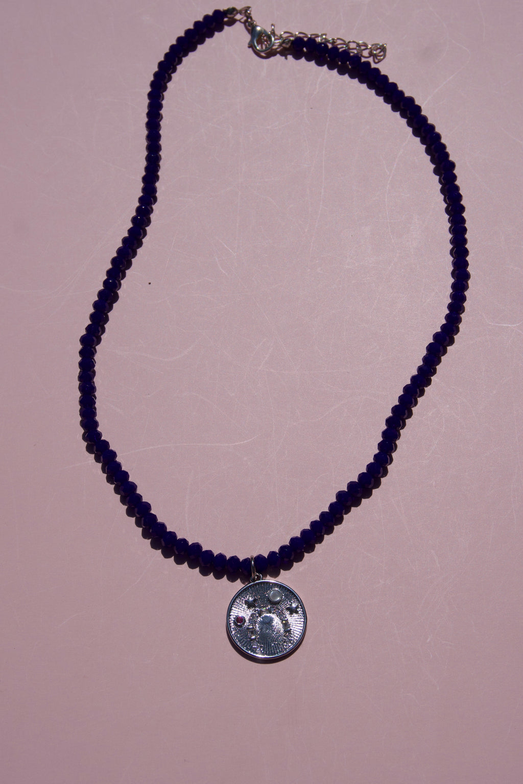 Navy beaded lucky coin necklace.