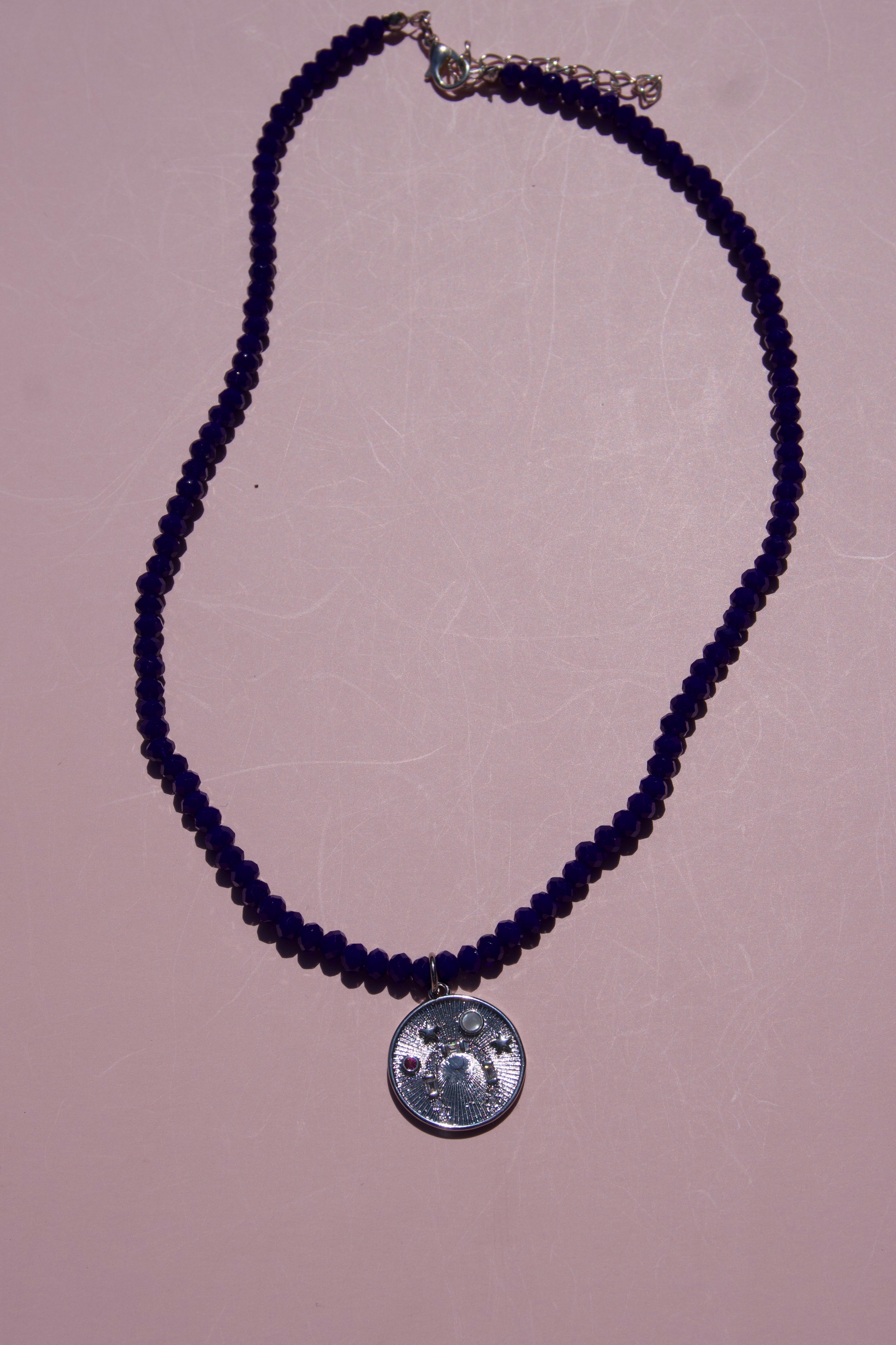 Navy beaded lucky coin necklace.