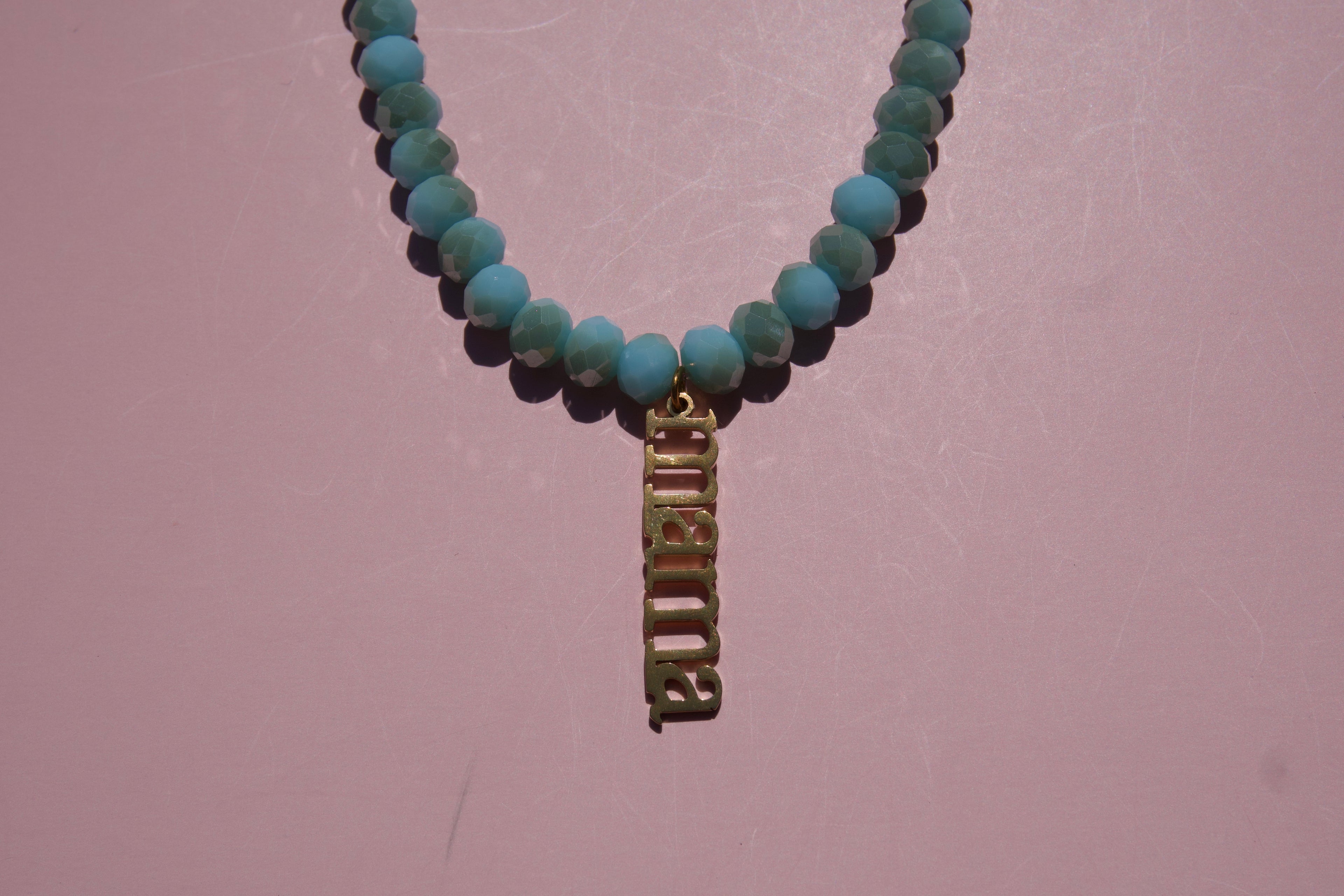 Baby Blue beaded necklace with Mama charm